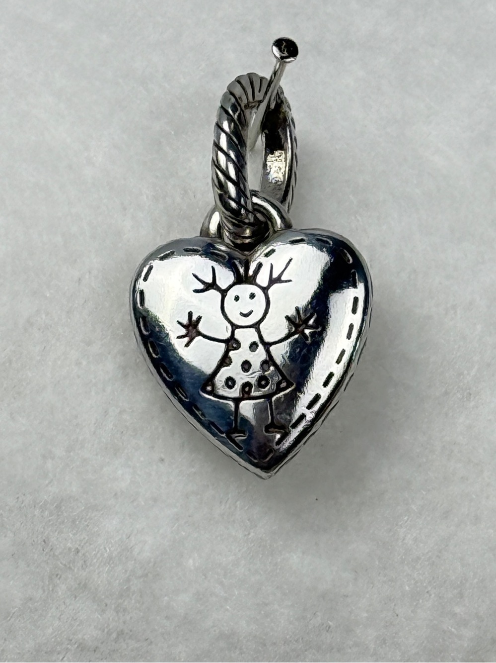Brighton Happy Girl Charm is Silver-plated Scrolled Heart